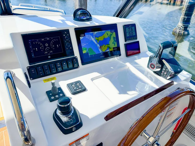 Slide: The Image of 2024 MJM 3 boat dashboard with navigation screens and controls. - 13