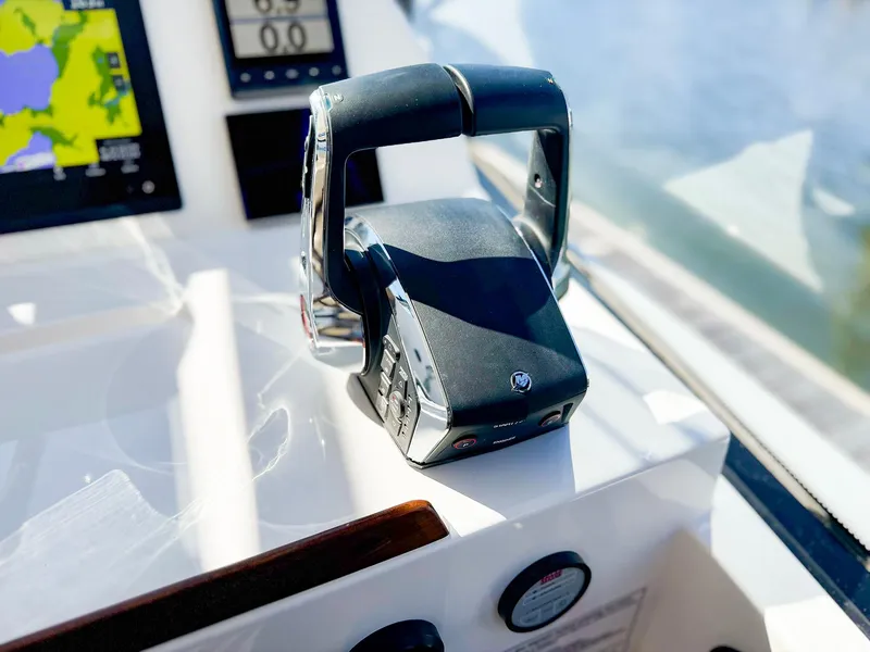 Slide: The Image of Throttle control on 2024 MJM 3 boat dashboard with navigation display. - 15