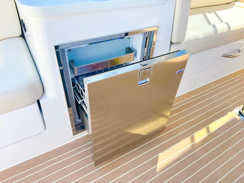 Slide: The Image of 2024 MJM 3 boat with open stainless steel refrigerator on deck. - 32