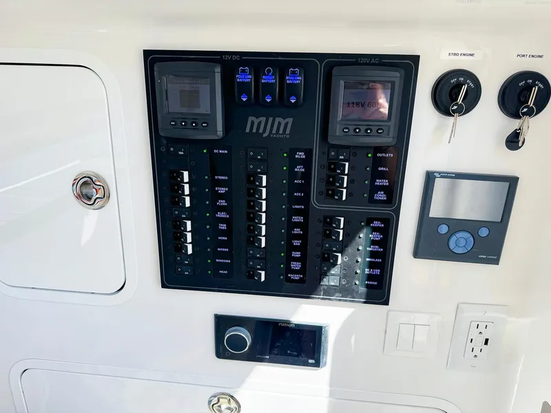 Slide: The Image of 2024 MJM 3 boat control panel with switches and gauges. - 35