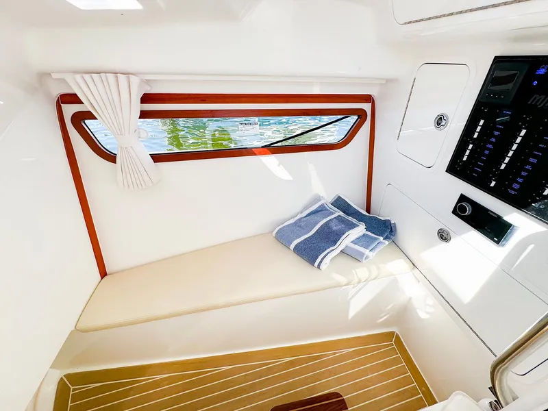 Slide: The Image of 2024 MJM 3 interior cabin with window, cushioned seating, and control panel. - 37
