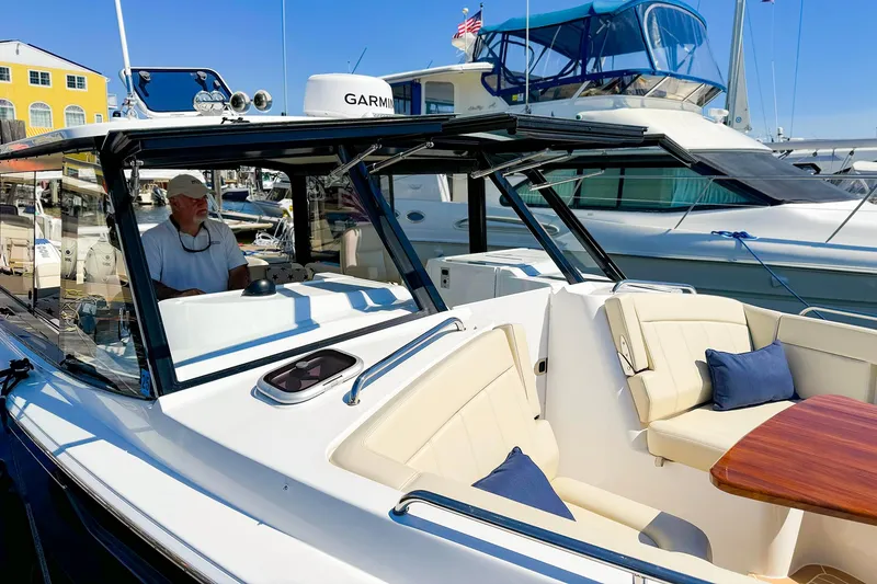 Slide: The Image of 2024 MJM 3 boat with luxurious seating and modern design in a marina setting. - 6