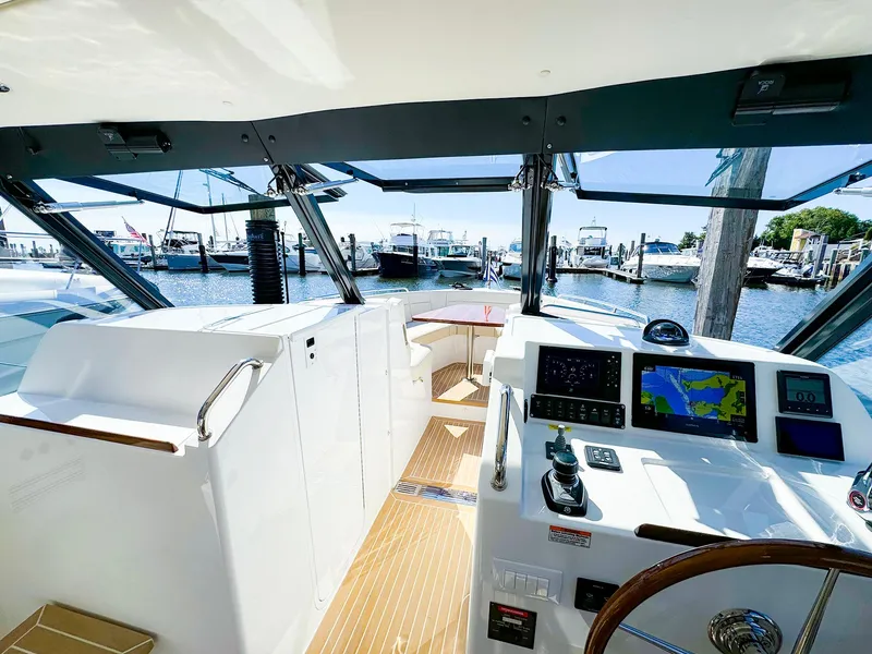 Slide: The Image of 2024 MJM 3 yacht cockpit with navigation screens and marina view. - 9
