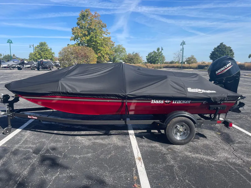 Slide: The Image of 2025 Tracker Bass Tracker Classic XL boat with cover in parking lot. - 2