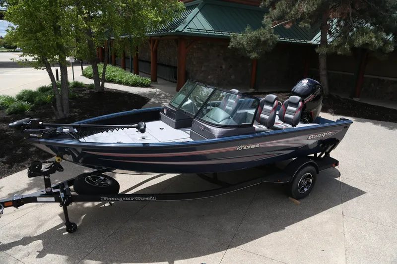 The Image of 2024 Ranger VS1782SC Angler boat on trailer, parked outdoors under cloudy sky. - 0