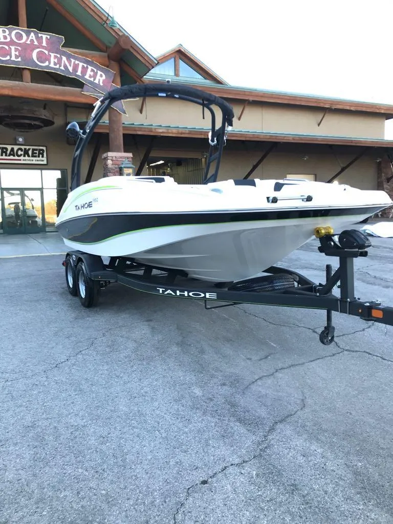 Slide: The Image of 2024 Tahoe 1950 boat on trailer outside dealership. - 10
