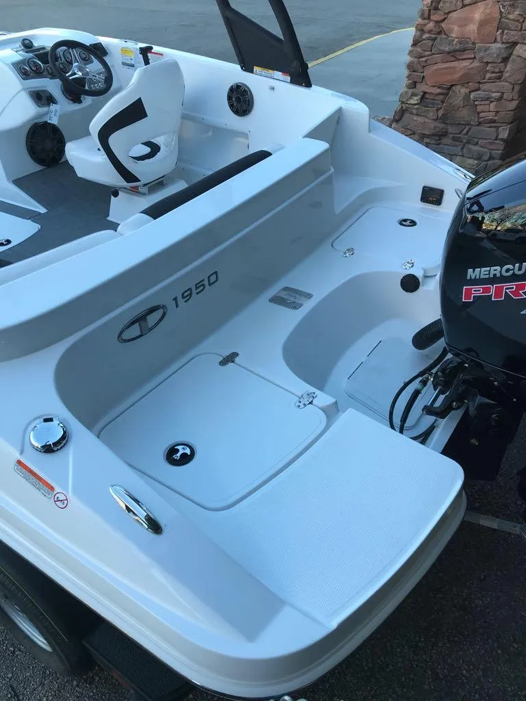 Slide: The Image of 2024 Tahoe 1950 boat with Mercury engine, sleek white design, spacious seating. - 11