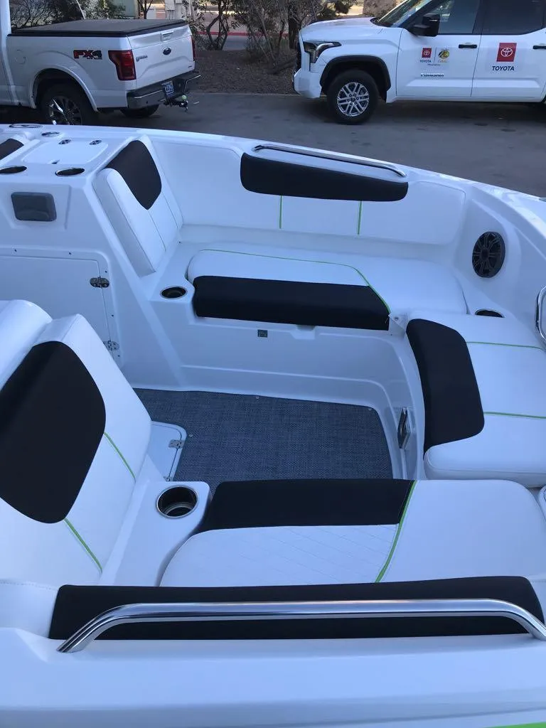 Slide: The Image of 2024 Tahoe 1950 boat interior with black and white seating, cup holders, and modern design. - 13