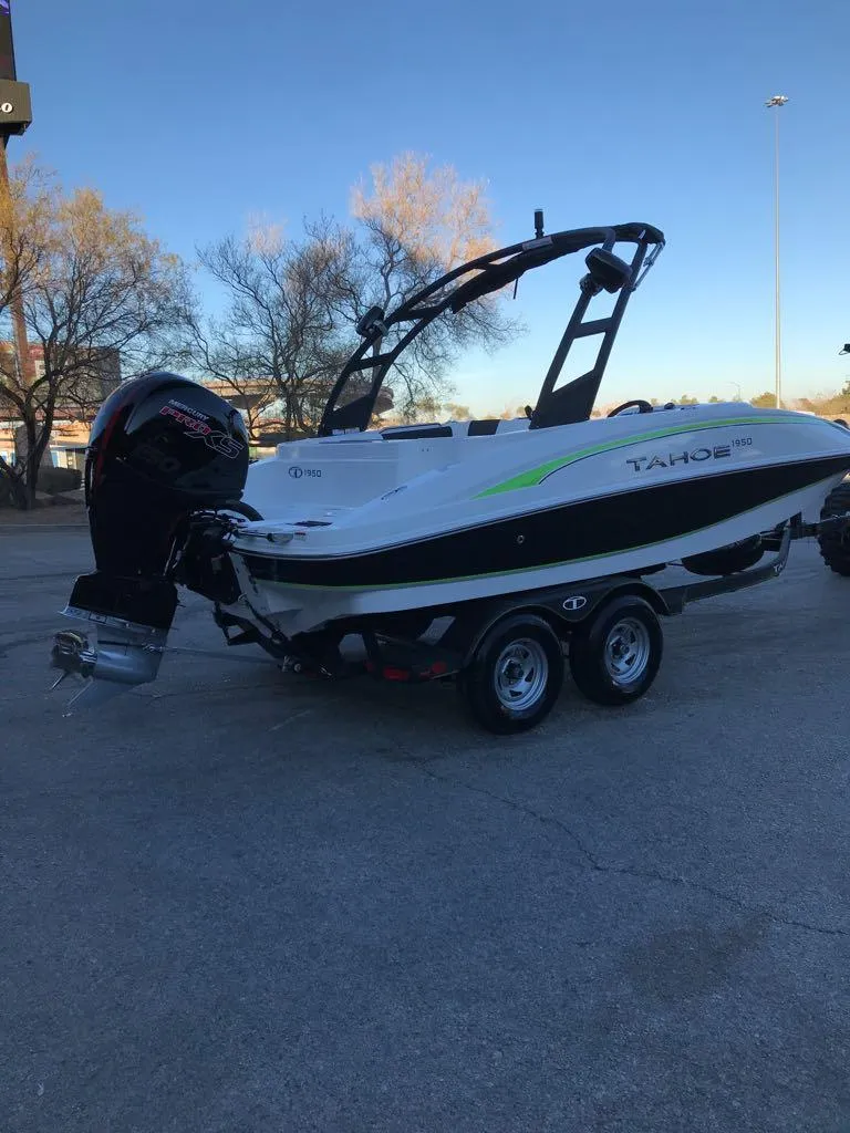 Slide: The Image of 2024 Tahoe 1950 boat on trailer, parked outdoors. - 15