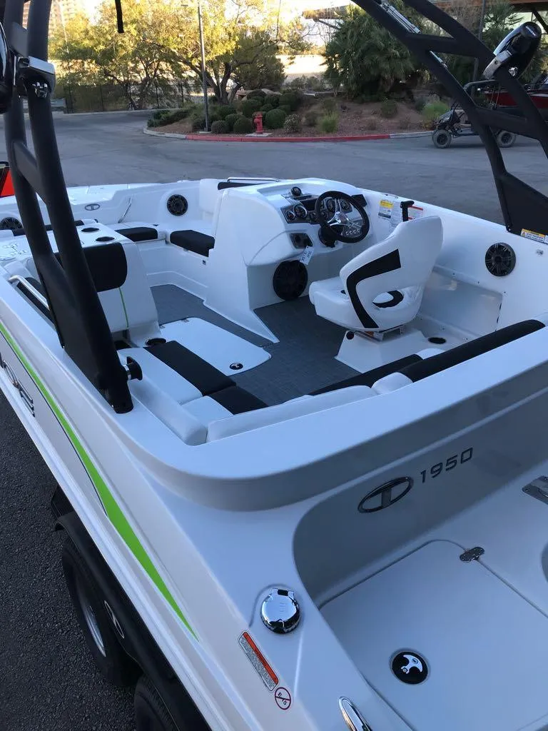 Slide: The Image of 2024 Tahoe 1950 boat interior with modern seating and controls. - 19
