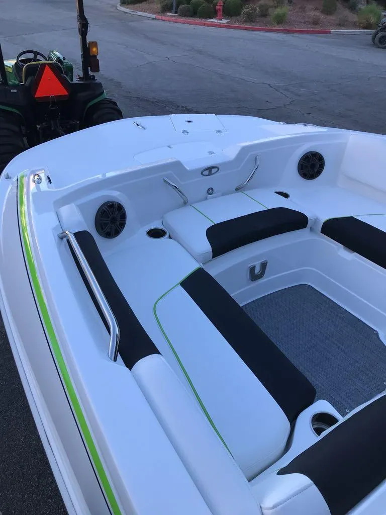 Slide: The Image of 2024 Tahoe 1950 boat interior with black and white seating, green accents. - 21