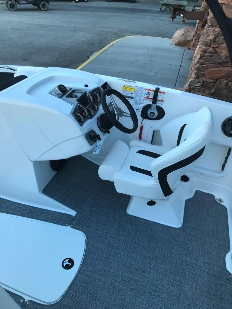 Slide: The Image of 2024 Tahoe 1950 boat cockpit with steering wheel and white seating. - 22