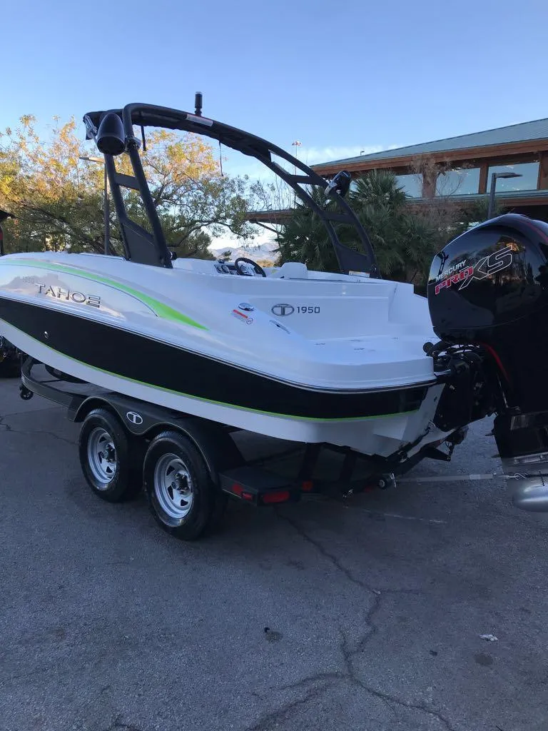 Slide: The Image of 2024 Tahoe 1950 boat on trailer, parked outdoors. - 5