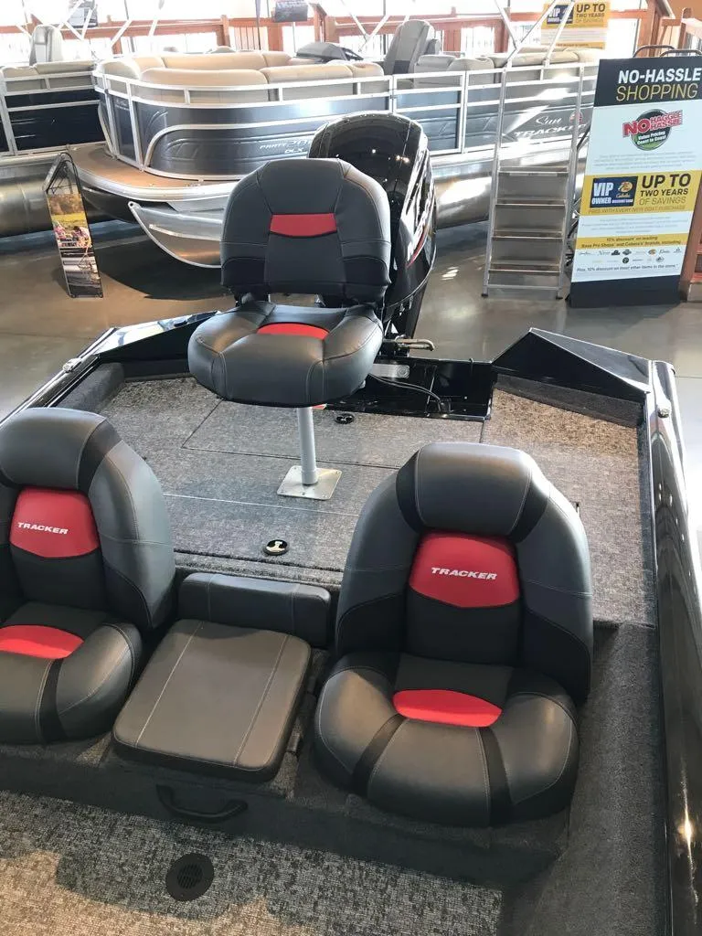 Slide: The Image of 2025 Tracker Pro Team 175 boat interior with cushioned seats in showroom. - 3