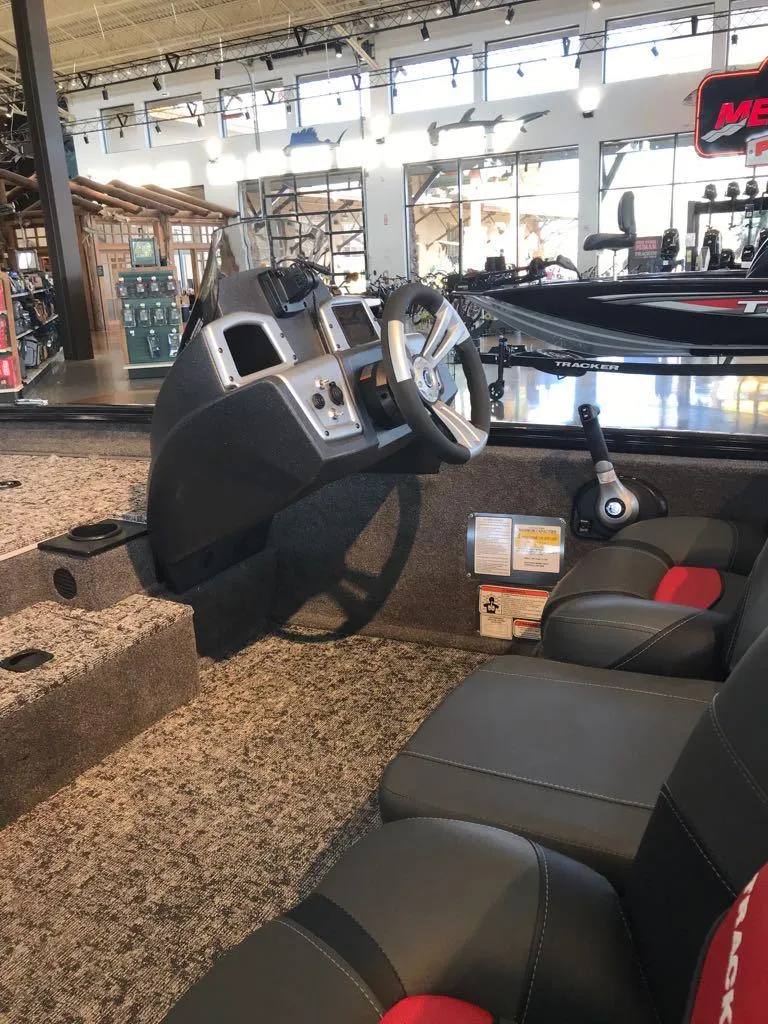 Slide: The Image of 2025 Tracker Pro Team 175 boat interior with steering console and seating. - 4