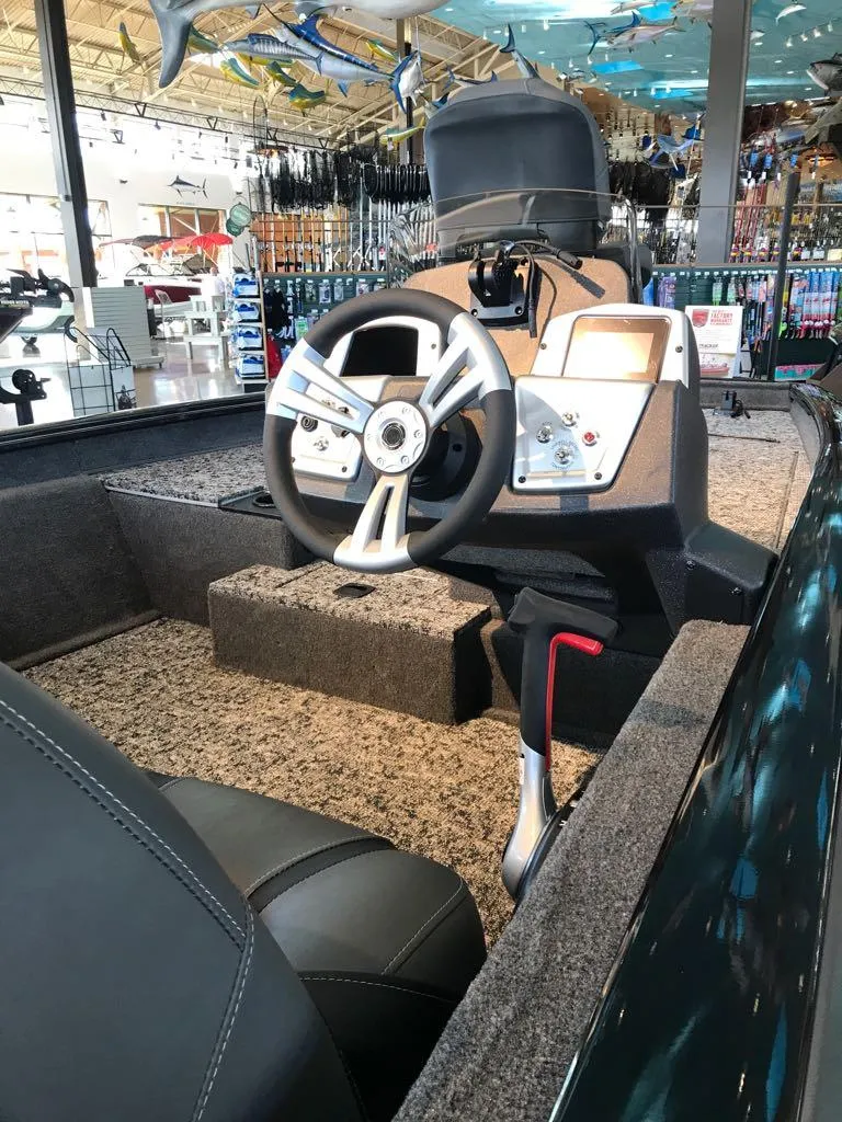 Slide: The Image of 2025 Tracker Pro Team 175 boat interior with steering wheel and controls. - 6