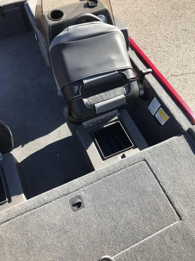 Slide: The Image of 2025 Tracker Bass Tracker Classic XL boat, red exterior, parked on a trailer. - 10