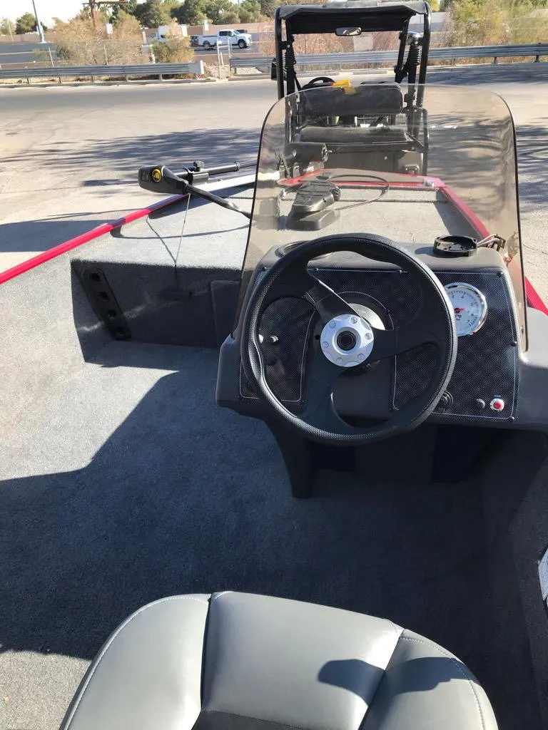 Slide: The Image of 2025 Tracker Bass Tracker Classic XL boat, red, parked on a trailer. - 8