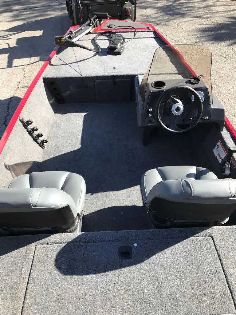 Slide: The Image of 2025 Tracker Bass Tracker Classic XL boat dashboard with steering wheel and gauges. - 9