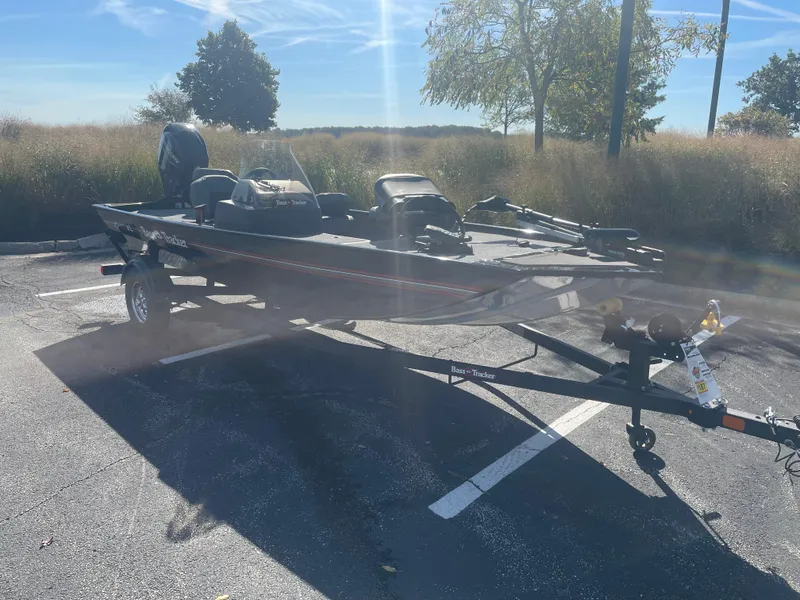 Slide: The Image of 2025 Tracker Bass Tracker Classic XL boat on trailer in sunny parking lot. - 4