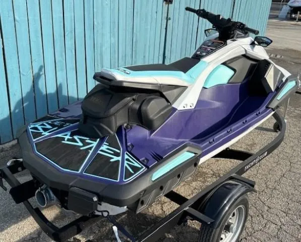 Slide: The Image of 2025 Yamaha WaveRunner JetBlaster LTD on trailer, blue and black design, parked by blue wall. - 2