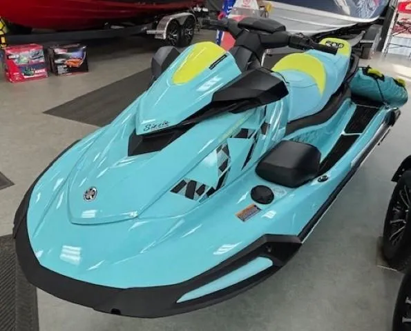 Slide: The Image of 2025 Yamaha WaveRunner VX Limited Ho in showroom, turquoise with yellow accents. - 1