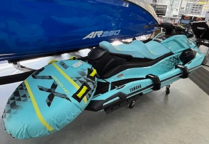 Slide: The Image of 2025 Yamaha WaveRunner VX Limited Ho in showroom, turquoise color, with attached inflatable accessory. - 3