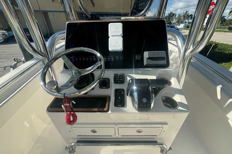 Slide: The Image of 2025 Bulls Bay 255CC boat console with steering wheel and controls. - 6
