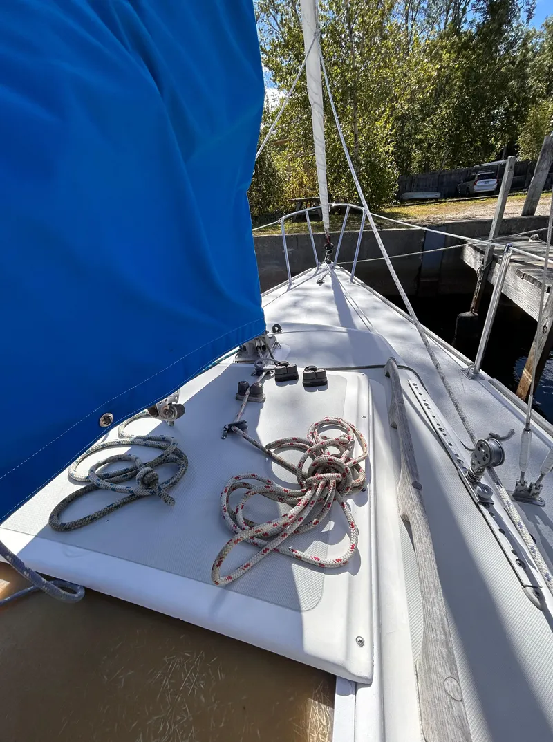 Slide: The Image of 1991 J Boats J/22 sailboat deck with ropes and blue sail cover. - 11