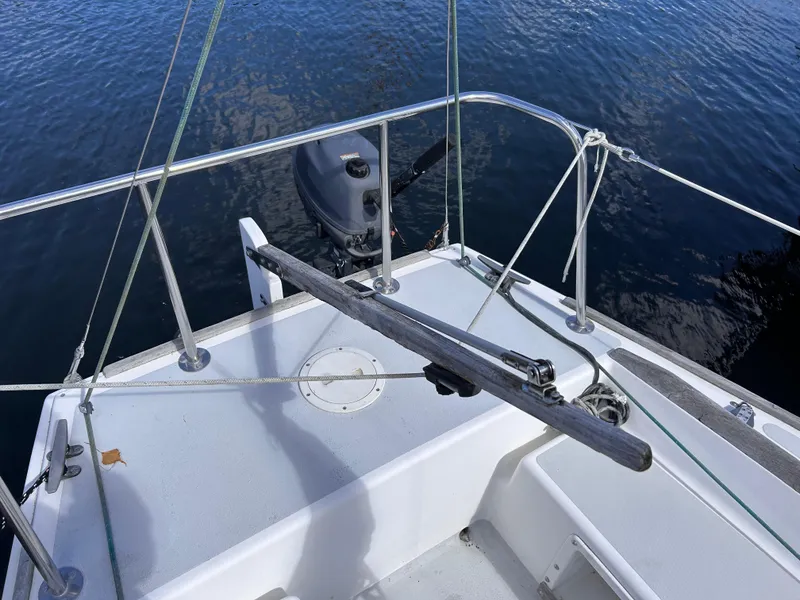 Slide: The Image of 1991 J Boats J/22 sailboat cockpit with outboard motor on calm water. - 15