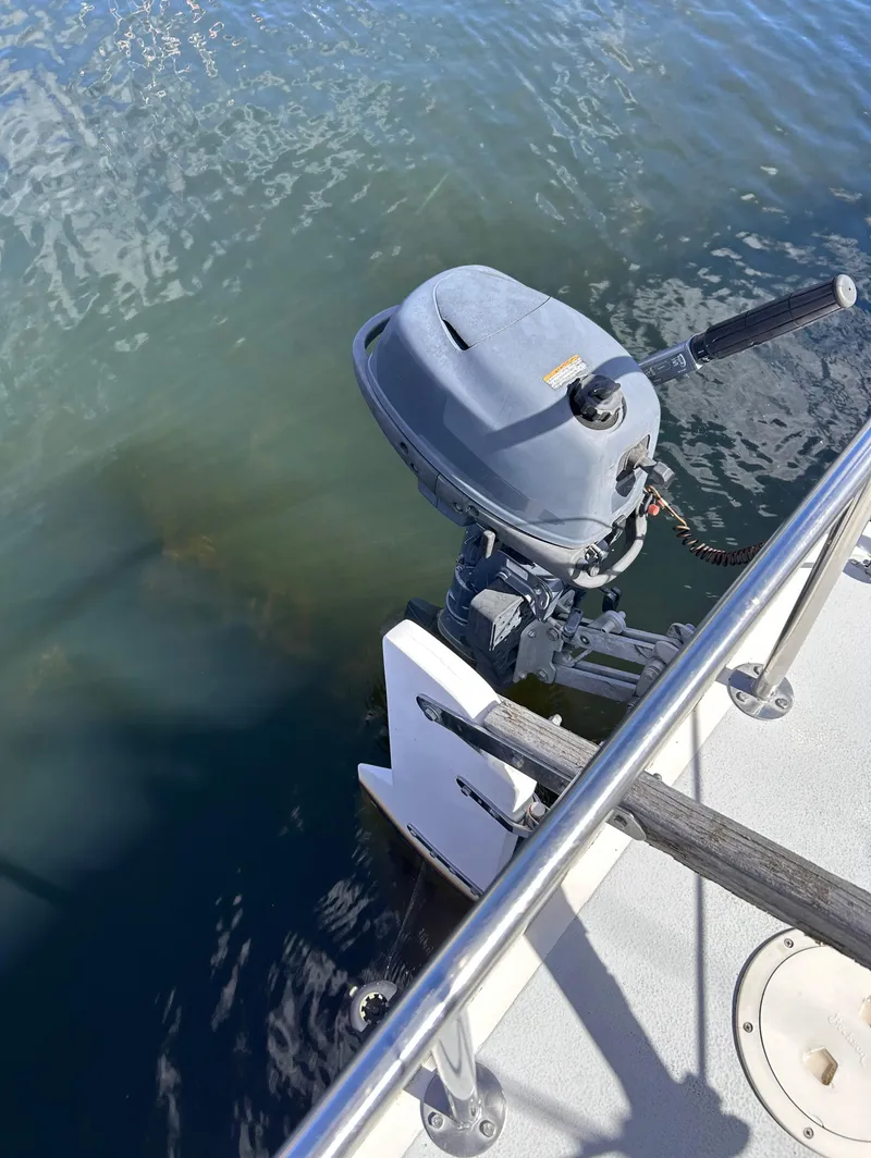 Slide: The Image of 1991 J Boats J/22 with outboard motor on calm water. - 17