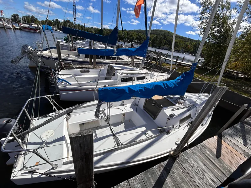 Slide: The Image of 1991 J Boats J/22 sailboat docked at a marina under a clear blue sky. - 2