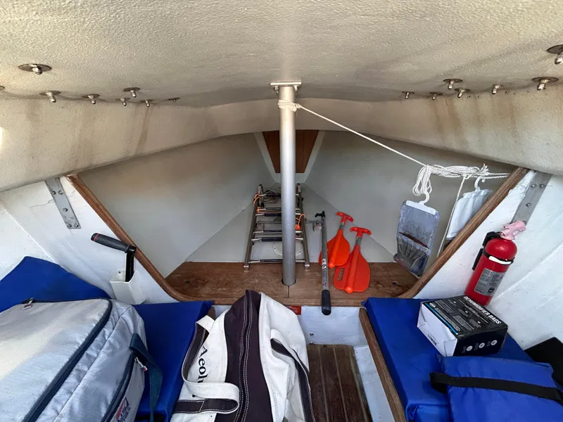 Slide: The Image of Interior of a 1991 J Boats J/22 sailboat, featuring storage and safety equipment. - 20