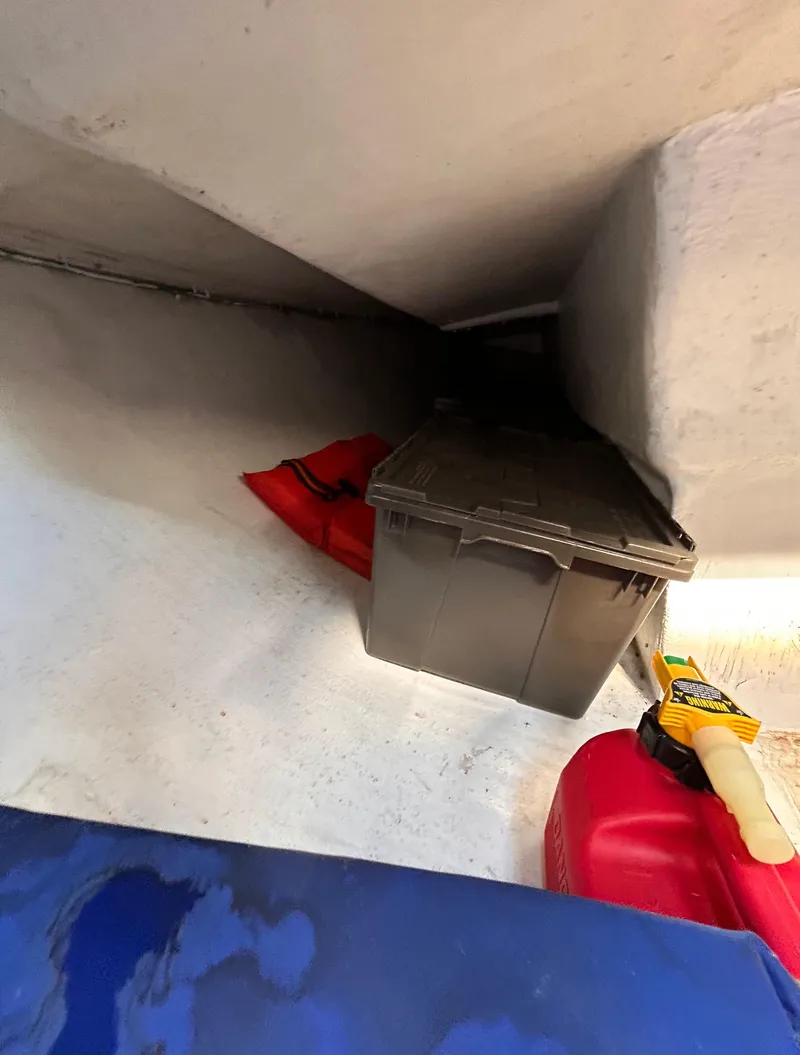 Slide: The Image of Storage area in 1991 J Boats J/22 with red fuel container and black storage box. - 23