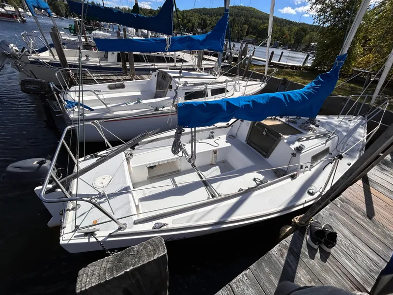 Slide: The Image of 1991 J Boats J/22 sailboat docked at marina with blue covers. - 4