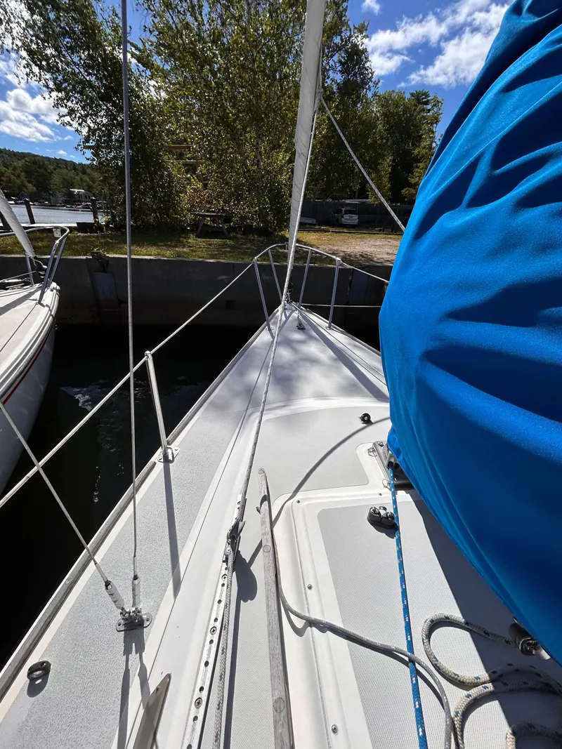 Slide: The Image of 1991 J Boats J/22 sailboat docked, featuring deck and rigging under a blue sky. - 7