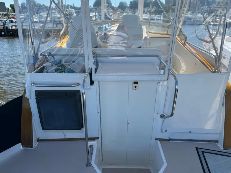 Slide: The Image of 2004 Nauset 33 boat interior with helm station and clear enclosure. - 11