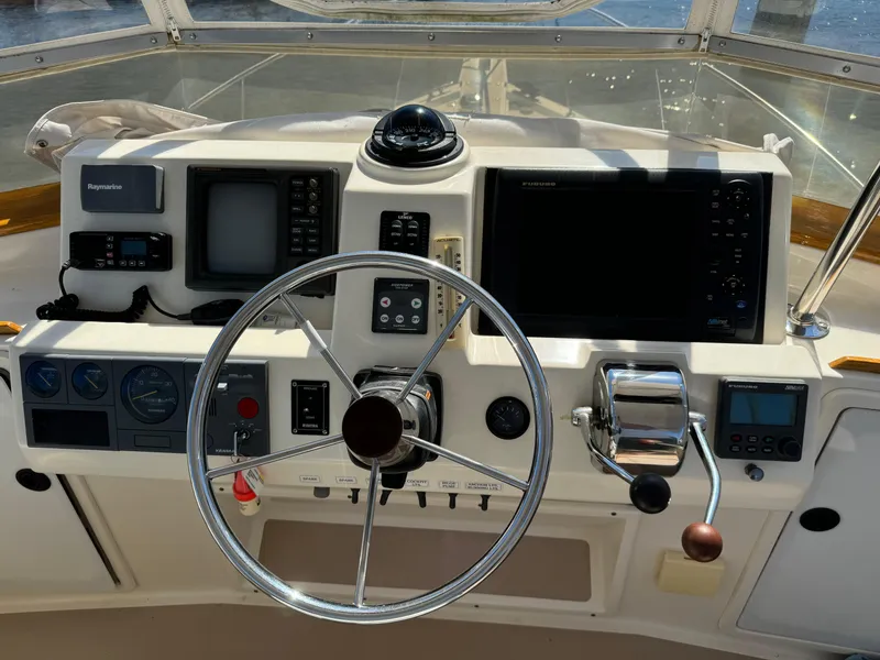 Slide: The Image of Boat helm of 2004 Nauset 33 with navigation equipment and steering wheel. - 13