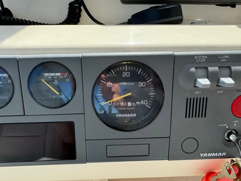 Slide: The Image of Close-up of a 2004 Nauset 33 boat dashboard with Yanmar engine gauges. - 17