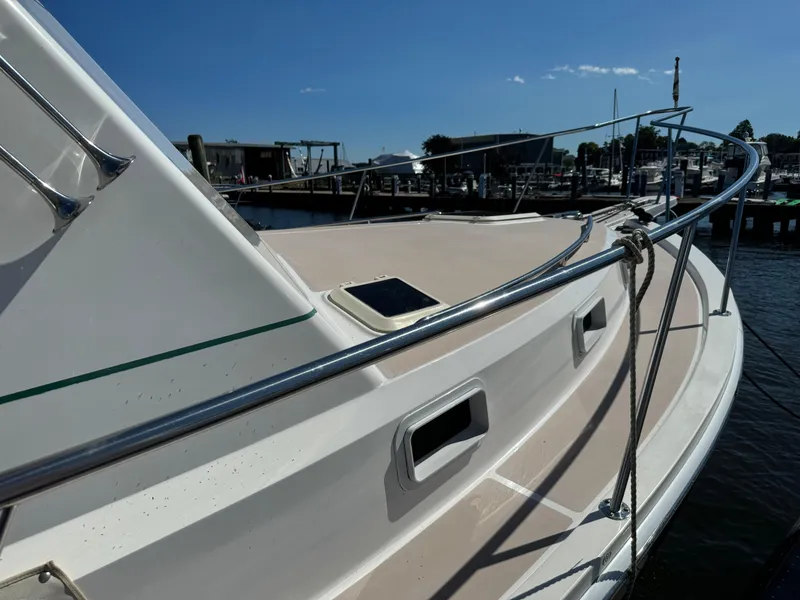 Slide: The Image of 2004 Nauset 33 boat docked at marina under clear blue sky. - 19