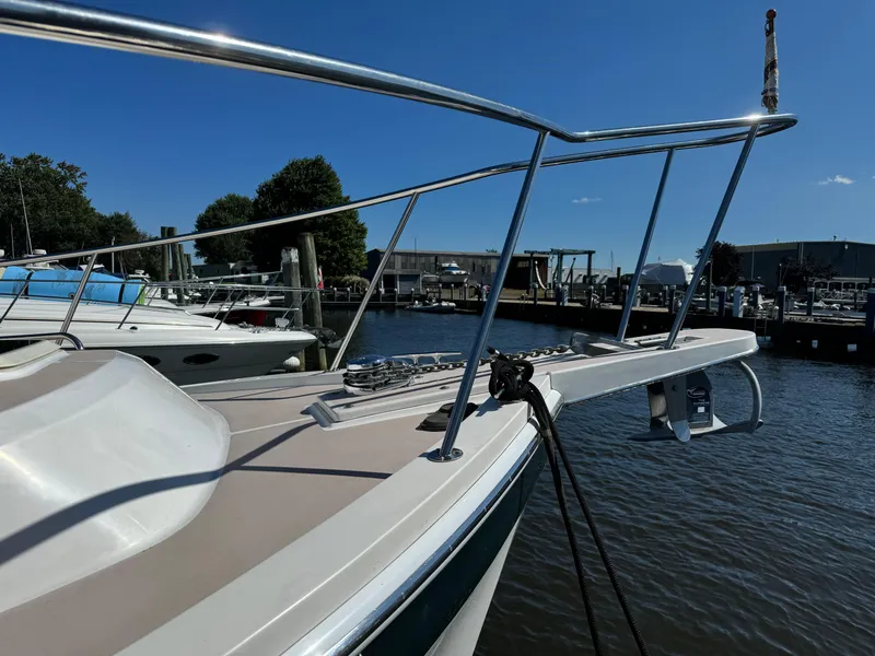 Slide: The Image of 2004 Nauset 33 boat docked at a marina under clear blue skies. - 20