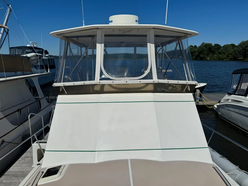 Slide: The Image of 2004 Nauset 33 boat docked at marina under clear blue sky. - 23