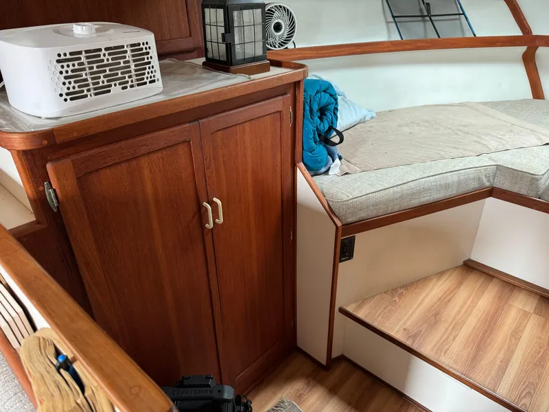 Slide: The Image of Cozy cabin interior of 2004 Nauset 33 boat with wooden cabinetry and seating area. - 30