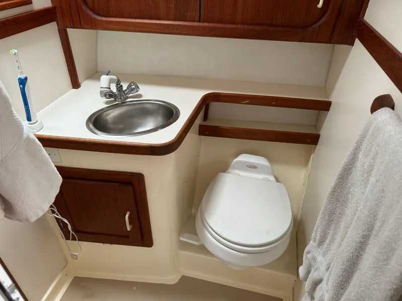 Slide: The Image of Compact bathroom in 2004 Nauset 33 Bridge Deck boat with sink and toilet. - 31