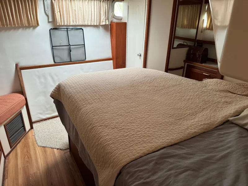 Slide: The Image of Cozy bedroom interior of 2004 Nauset 33 boat with wood flooring and beige bedding. - 32