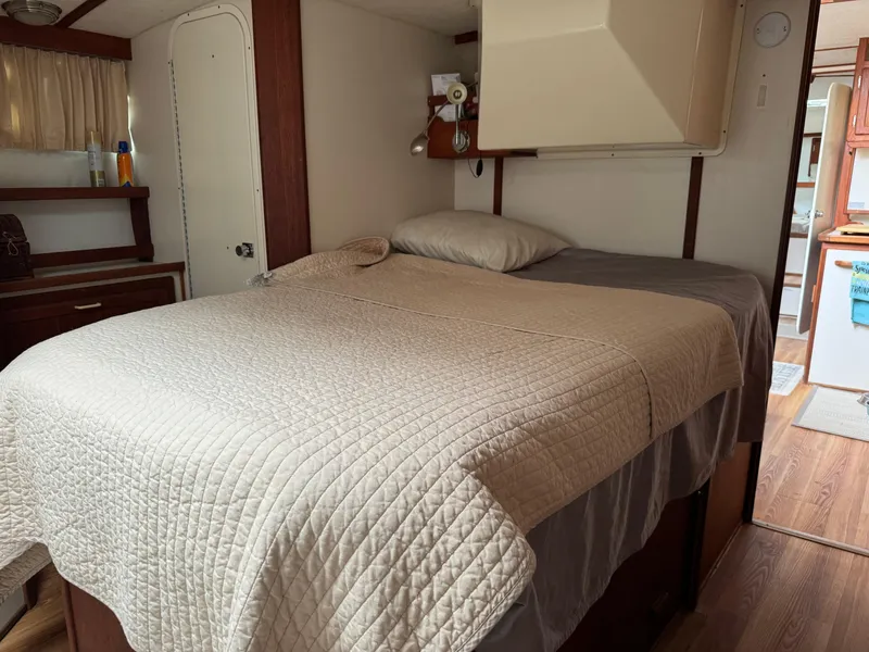 Slide: The Image of Cozy bedroom interior of 2004 Nauset 33 RV with neatly made bed. - 33