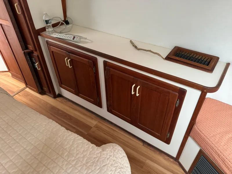 Slide: The Image of Wooden cabinetry and countertop inside a 2004 Nauset 33 boat cabin. - 34