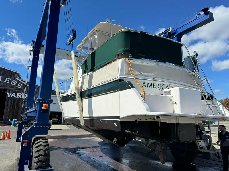 Slide: The Image of 2004 Nauset 33 boat lifted at a shipyard under clear blue sky. - 39