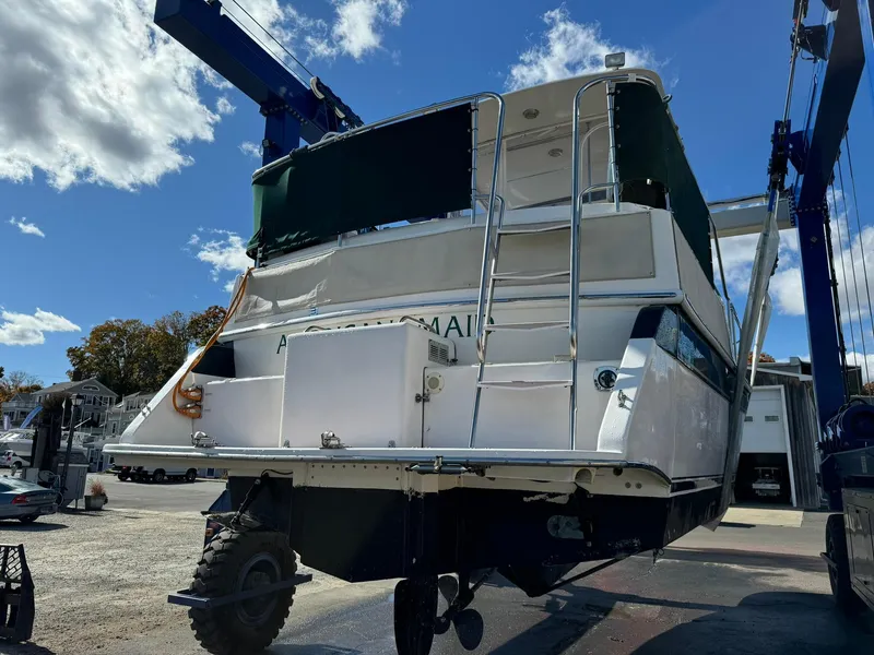 Slide: The Image of 2004 Nauset 33 boat in dry dock, rear view under clear sky. - 40