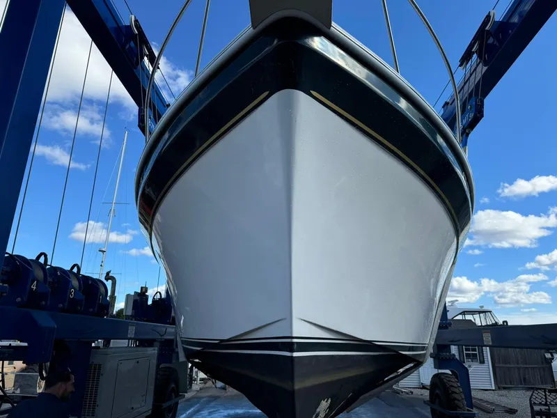 Slide: The Image of 2004 Nauset 33 boat in dry dock, viewed from the front under a blue sky. - 44